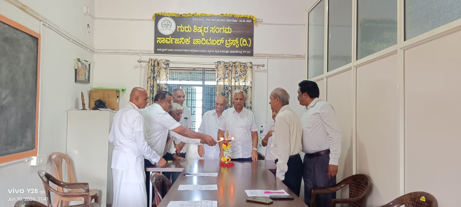 Trustees lighting the ceremonial lamp