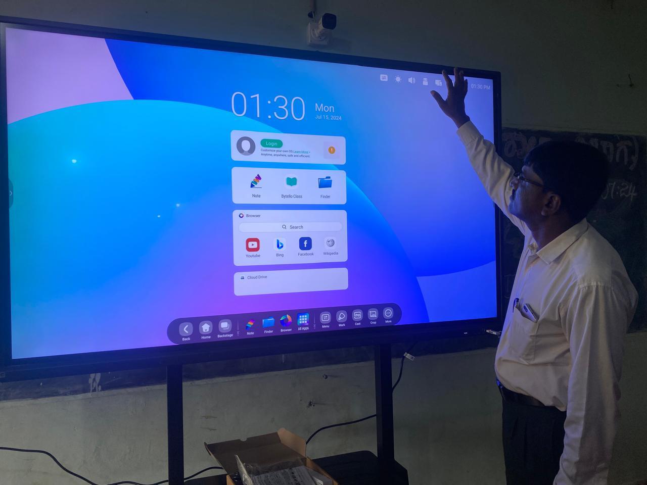A teacher using a large smart board